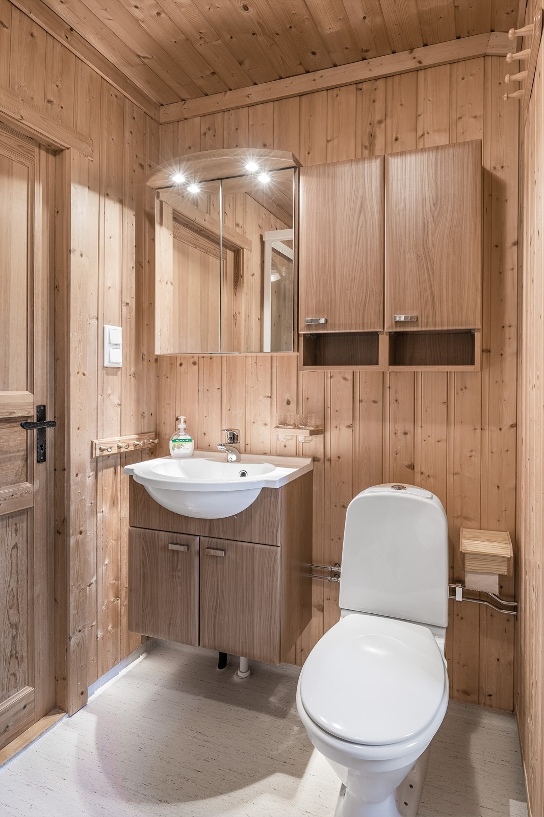 Moderne innredning med overskap, speilskap og underskap med innfelt servant samt en elektrisk håndkletørker Galleribilde