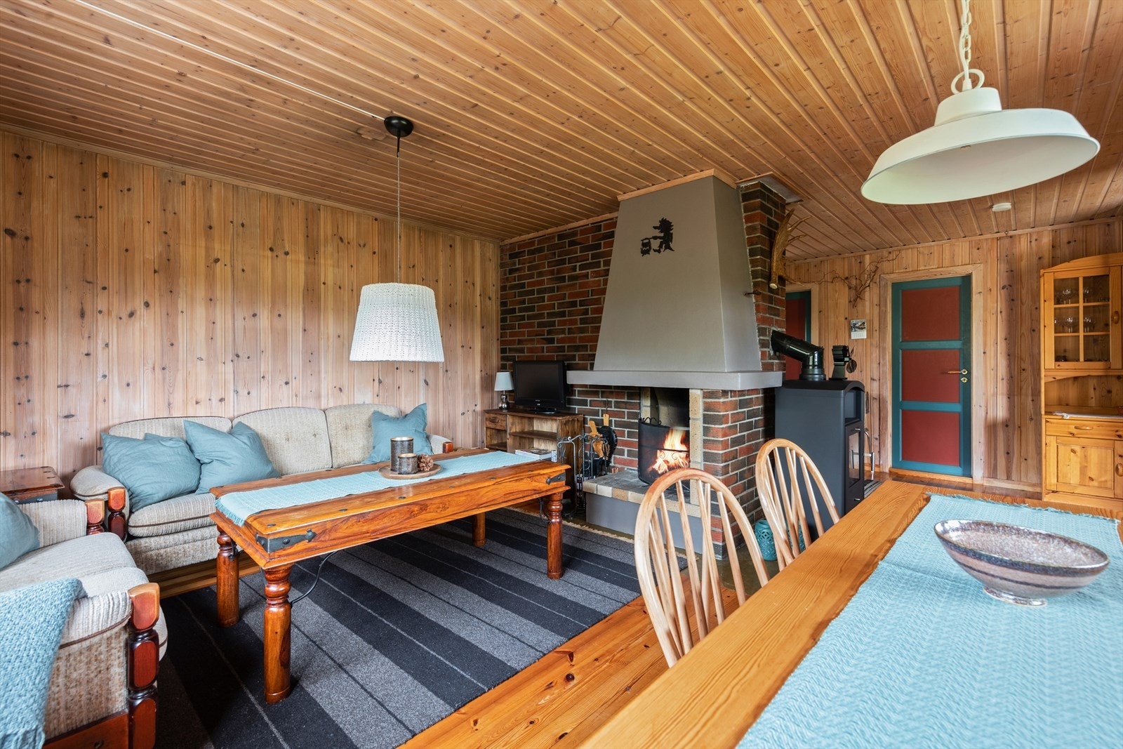 Her er det fin plass til både sofa og TV krok du har en flott tegelsteinspeis i stuen som gir en hyggelig stemning til rommet. Galleribilde