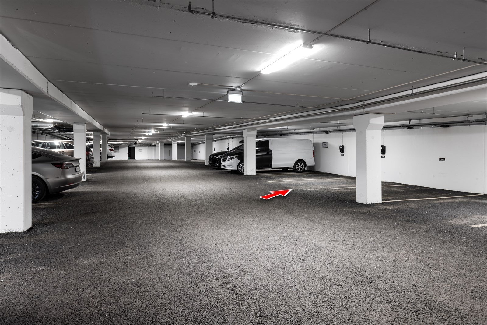 Parkeringsplass markert med installert elbillader. Galleribilde