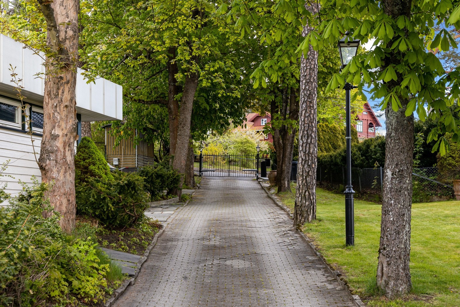 Fjernstyrt port og egen allé - garasje til venstre og biloppstillinger på egen tomt Galleribilde