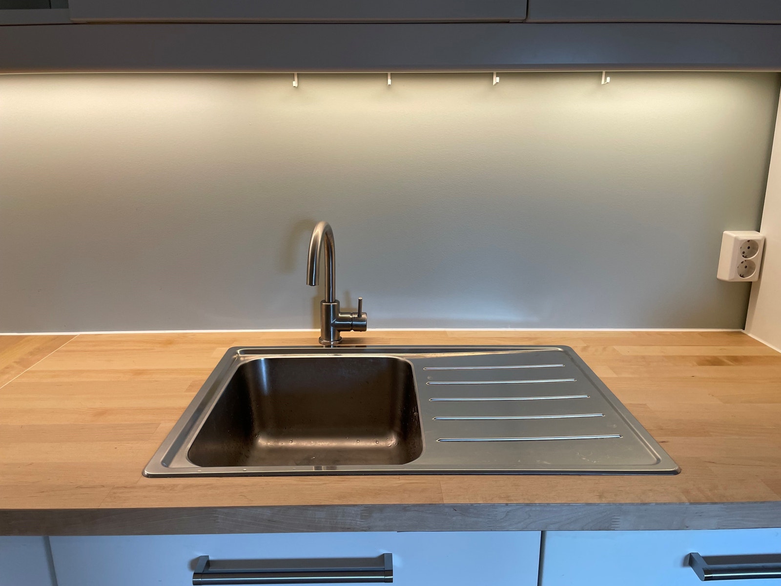 Vaskekum i stål med avrenningsbrett på siden. Galleribilde