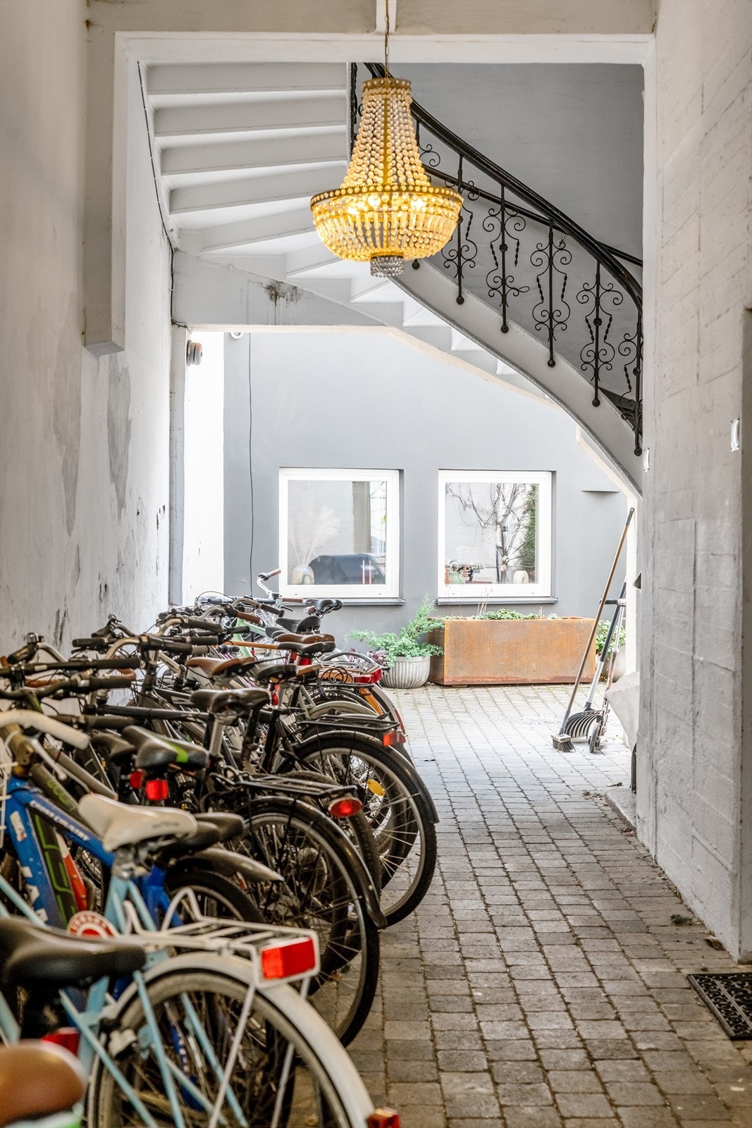Lekkert inngangsparti med sykkelparkering og vakre detaljer i trapp, samt flotte lysekroner Galleribilde