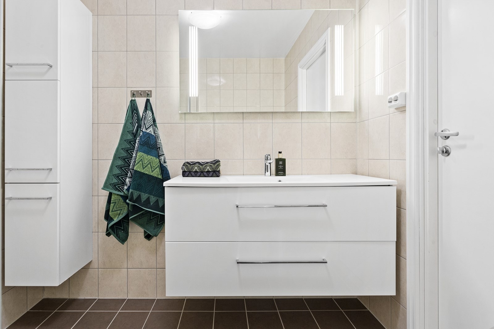 Badet er utstyrt med toalett, servant med skuffer og dusjnisje med innfellbare glassdører. Galleribilde