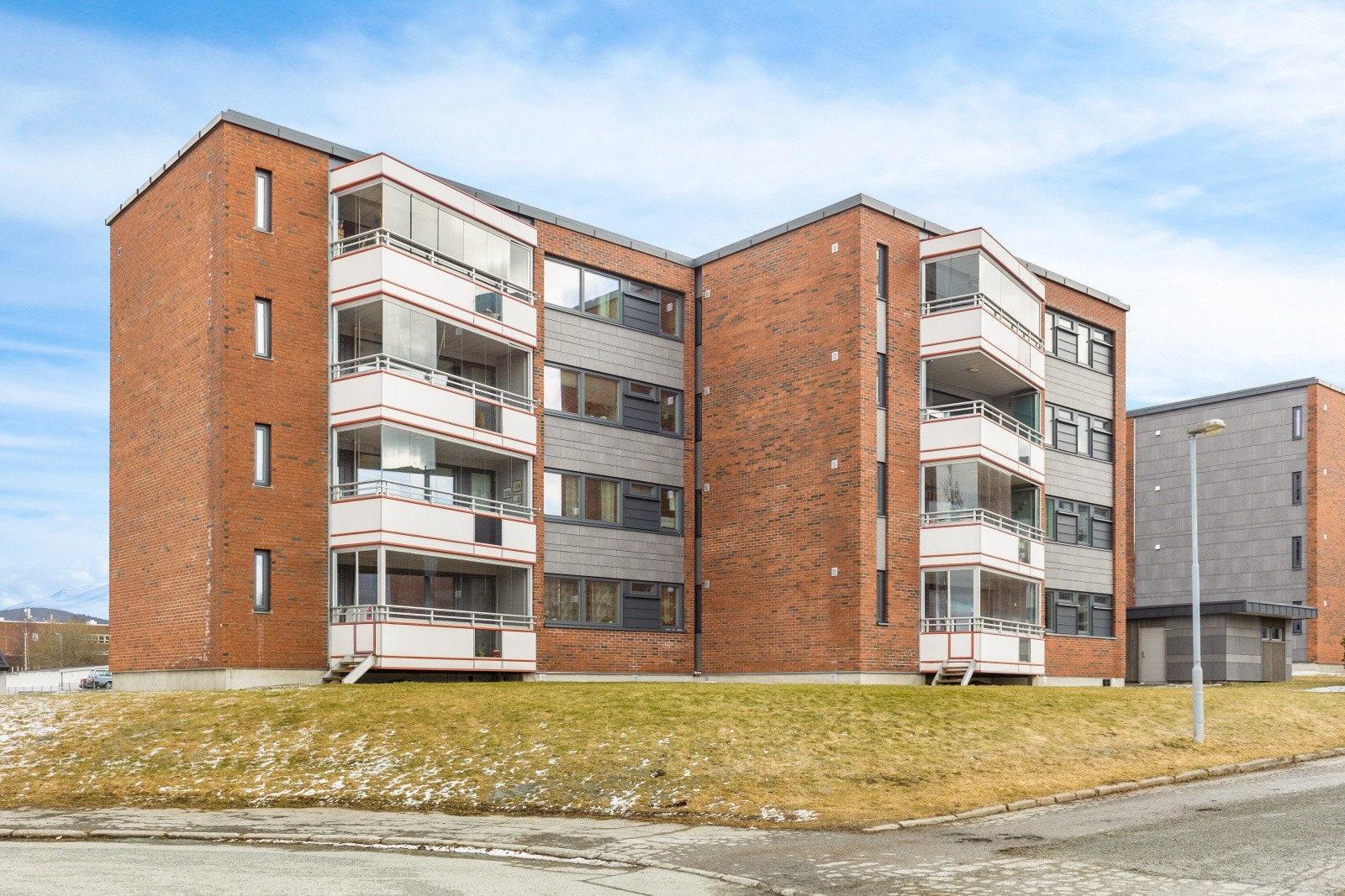 Fasade. Rikelig med parkeringsplasser rett utenfor blokka. Galleribilde