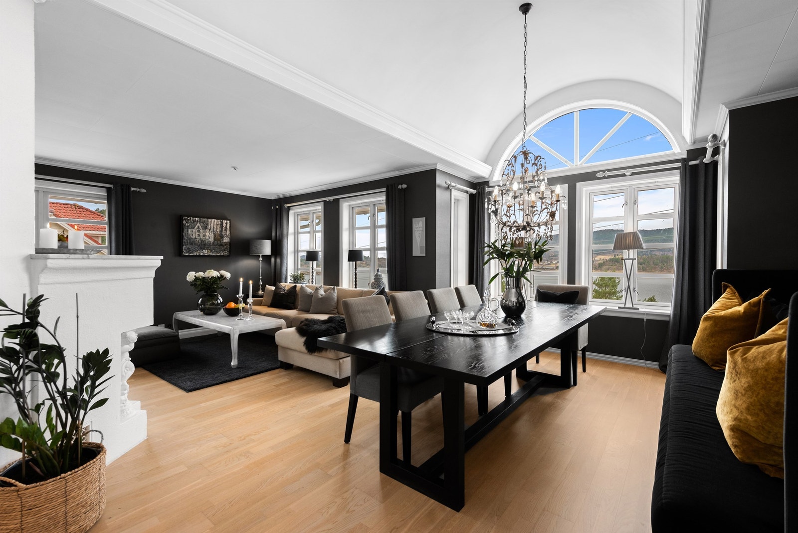 Romslig L-formet stue med parkett på gulv. Flott utsikt fra stue. Galleribilde