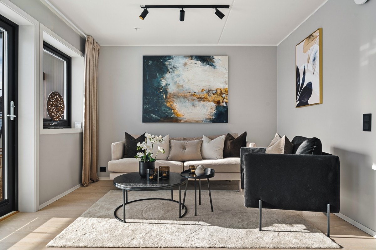 Videre inn kommer du til stue/kjøkken som er i åpen løsning. Legg merke til de sorte vindusrammene og spottskinnene i taket. Galleribilde