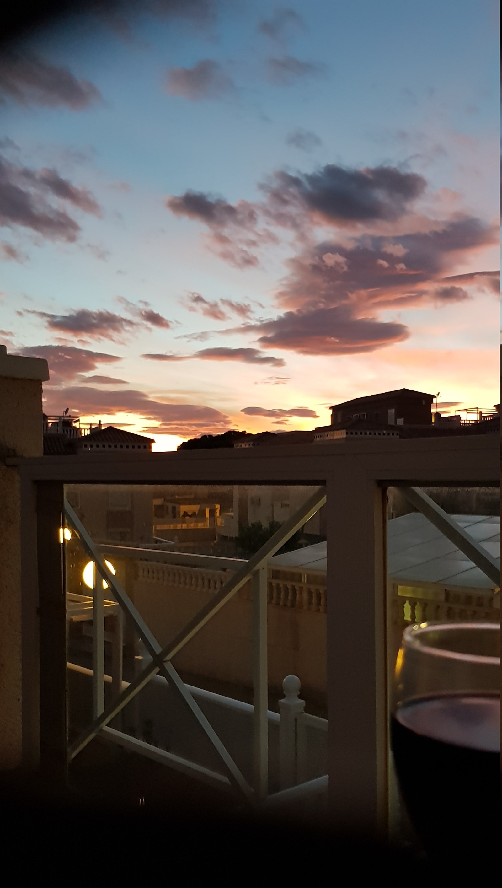 Rødt i glasset og rødt på kveldshimmelen Galleribilde