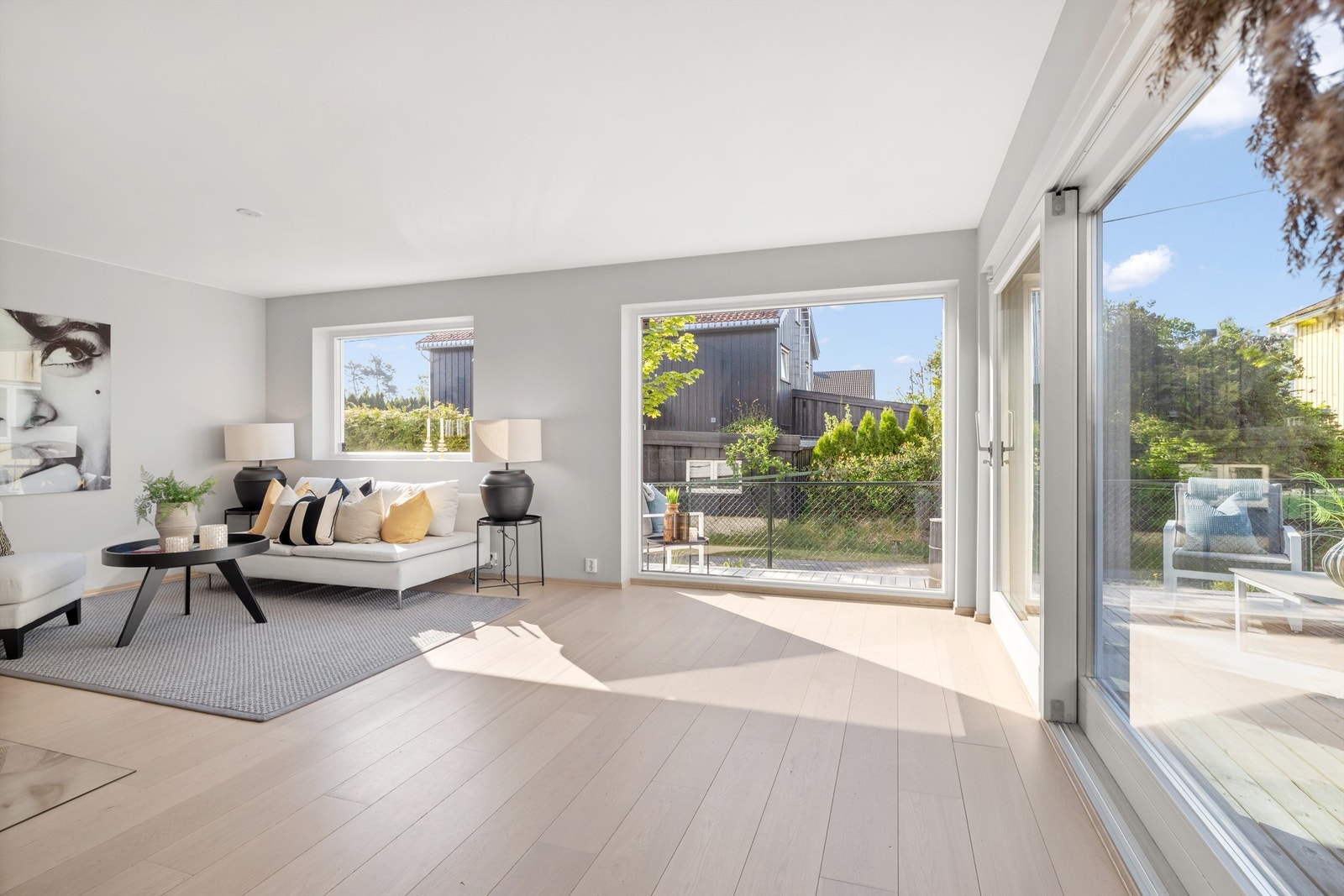 Stue med utgang til solrik terrasse og hage Galleribilde