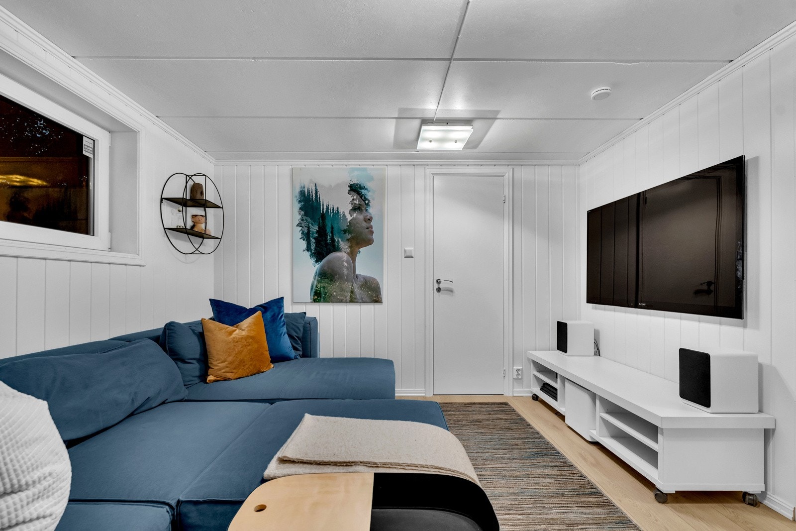 I underetasjen er det en ekstra stue. Denne kan gi ytterligere spillerom og privatliv for alle i familien. Stuen har plass for sofa, bord og tv-møblement. Et høytsittende vindu fyller rommet med naturlig lys, og lysmalte panelvegger gir fin refleksjon Galleribilde