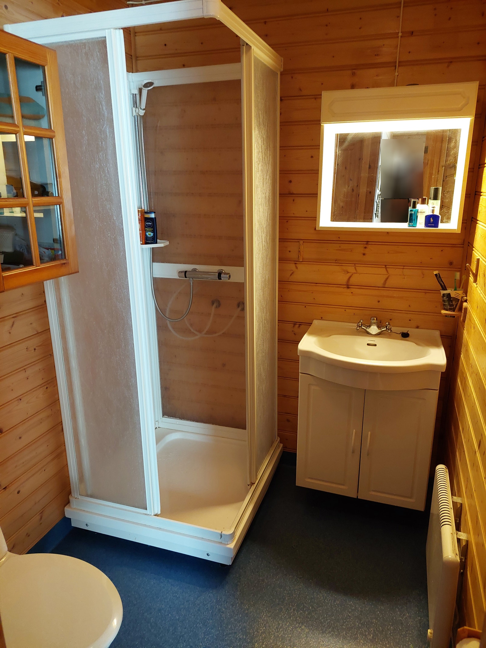 Bad med servantskap, dusjkabinett og toalett. Galleribilde