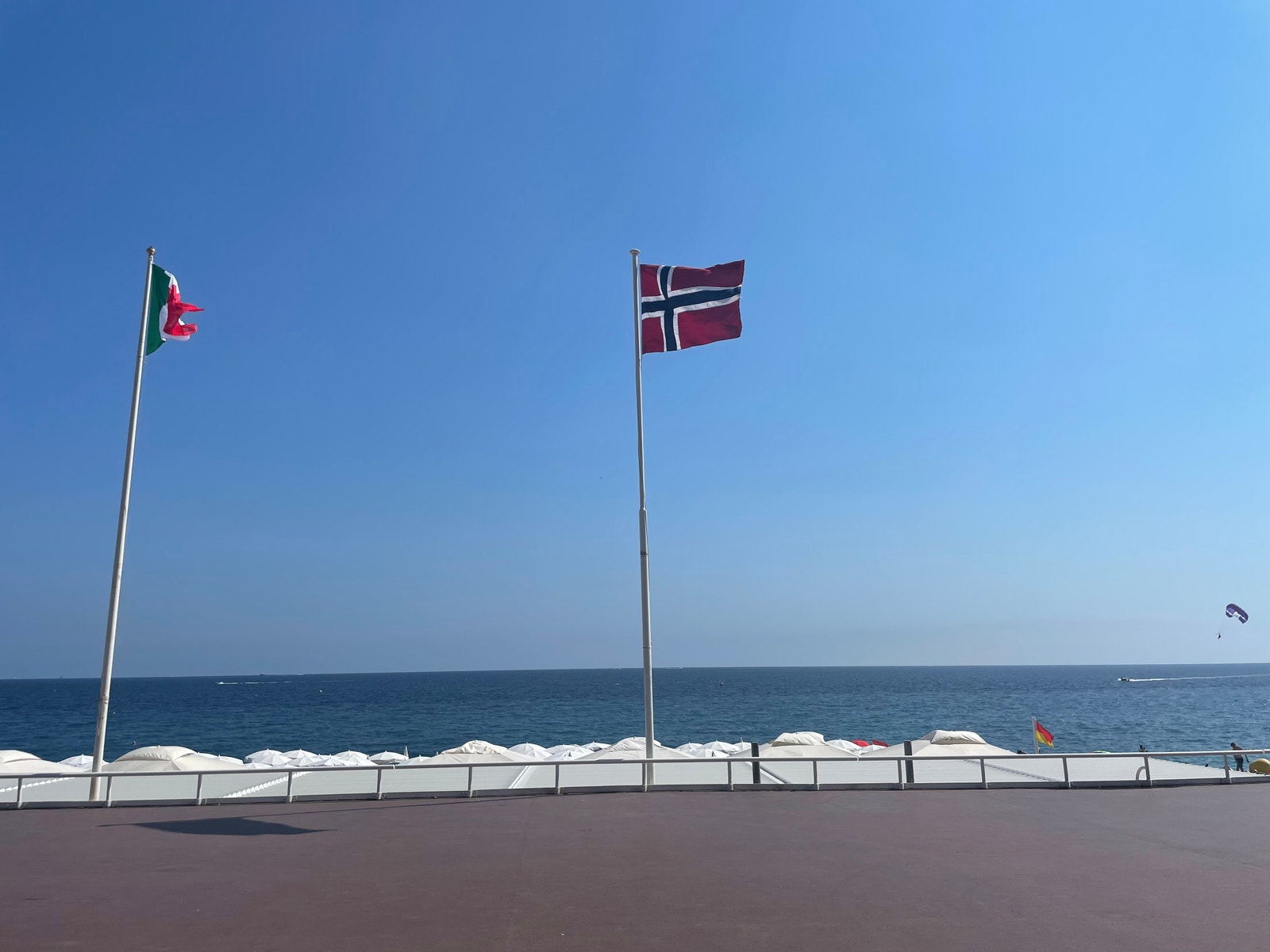 Det norske flagget vaier ved stranden nærmest leiligheten Galleribilde