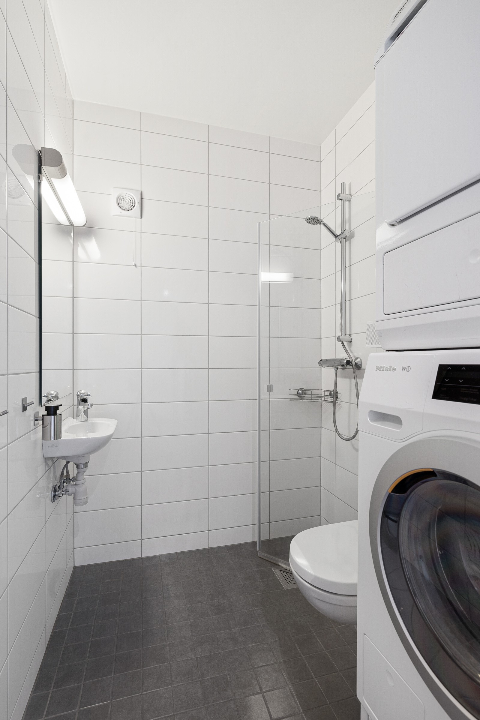 Boligens andre bad/vaskerom har også dusj, wc, samt opplegg for vaskemaskin og plass for tørketrommel.