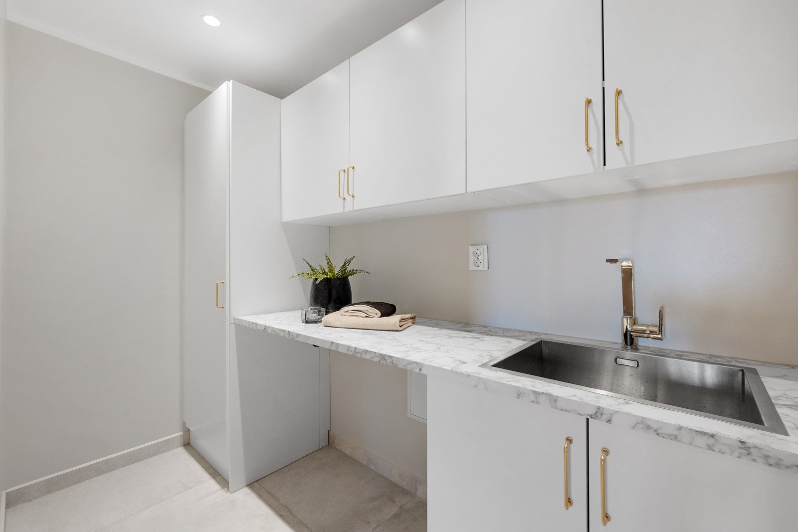 Meget praktisk separat vaskerom med plass for vaskemaskin og tørketrommel under benkeplaten. 200 liters vv.bereder i høyskap. Galleribilde