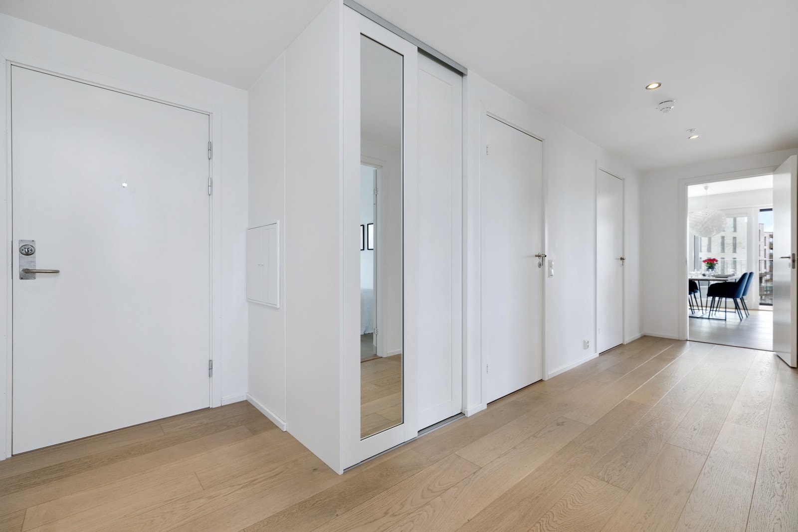Romslig entré, med plassbygget skyvedørsgarderobe fra Acme Interiør Galleribilde