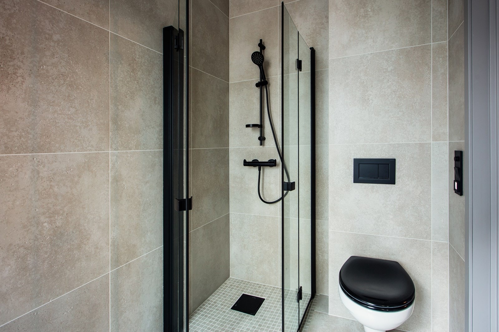 Badet i 1. etg har dusjhjørne, vegghengt toalett og baderomsinnredning med skuffer. Galleribilde