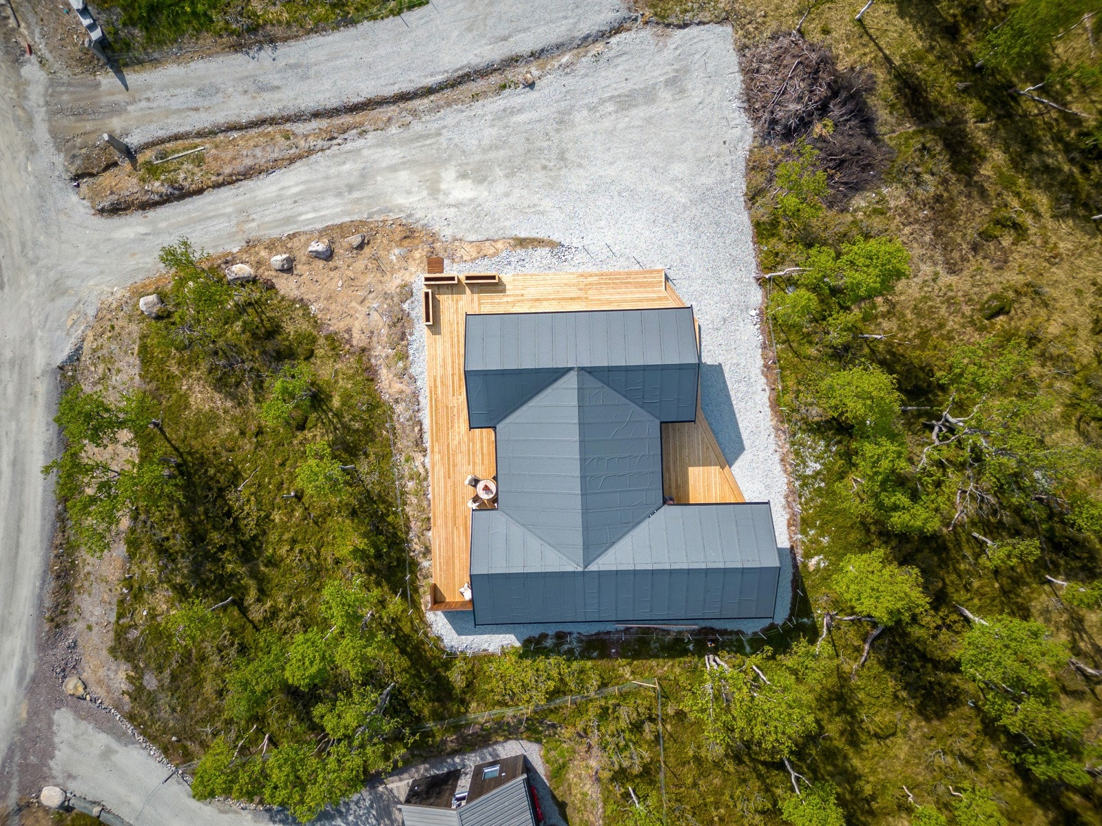 Tomta består for det meste av naturlig vegetasjon og gruset innkjørsel/gårdsplass Galleribilde