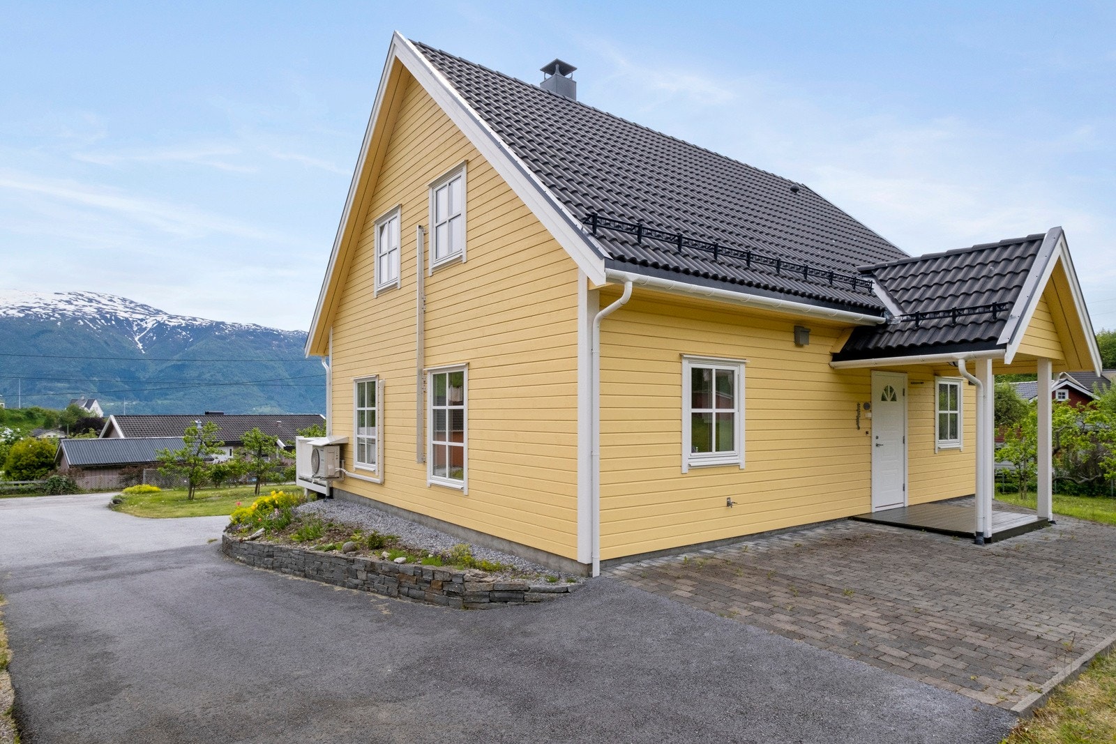 Eigedomen er fint opparbeidd med romsleg asfaltert tun, inngangsparti med beleggningsstein og elles beplantning med blomsterbed. Galleribilde