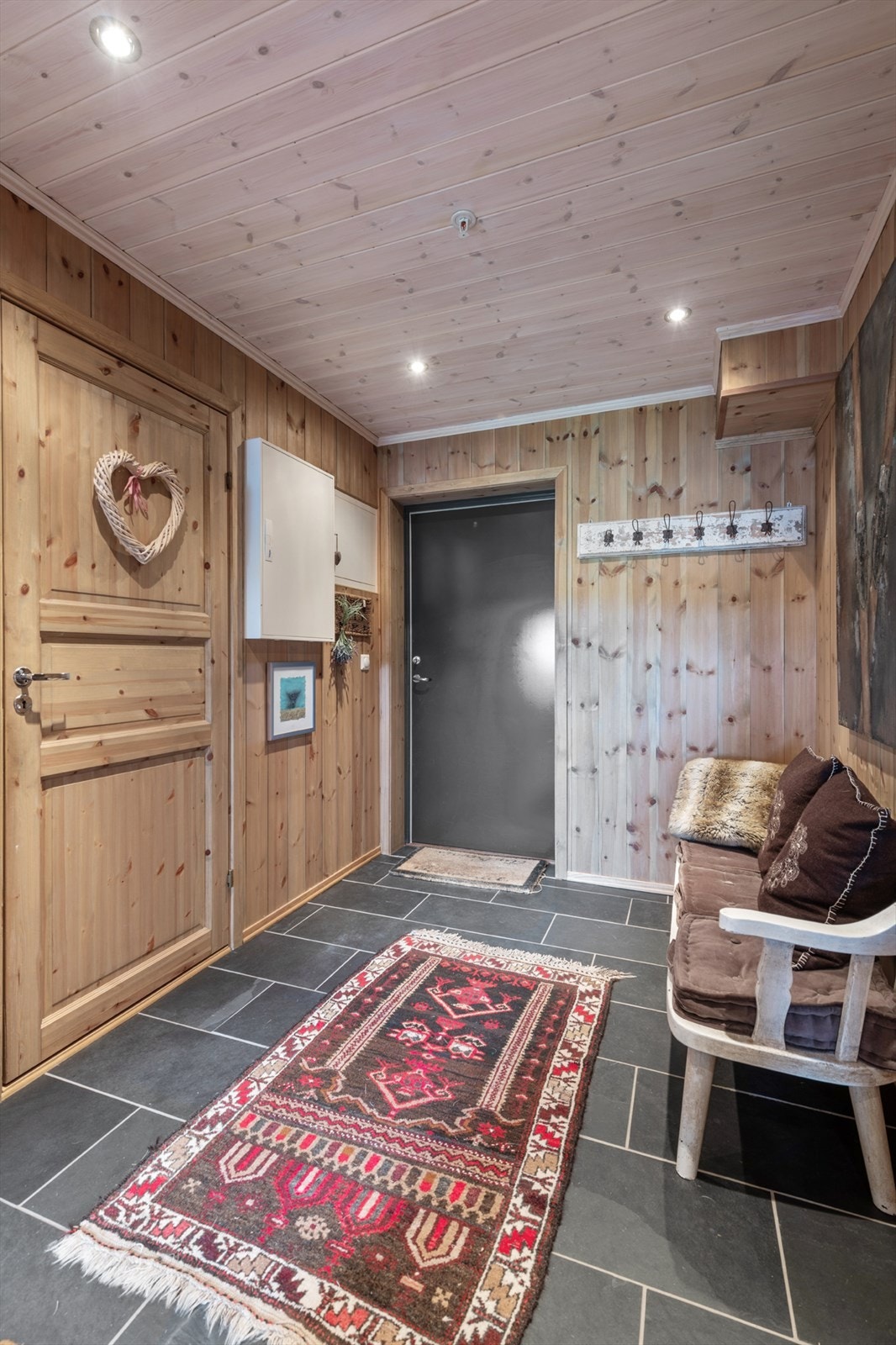 Romslig entre med knaggrekke. Fliser på gulvet med gulvvarme. Galleribilde