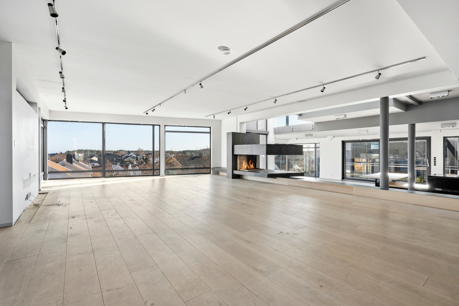 Stue med peis og store vindusflater Galleribilde