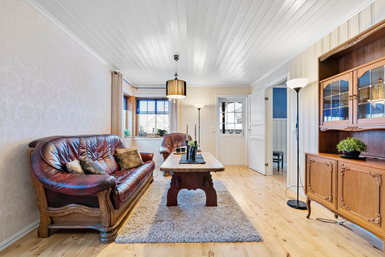 Stue med dør ut til takoverbygget veranda med videre adkomst til hagen som vender mot sør Galleribilde