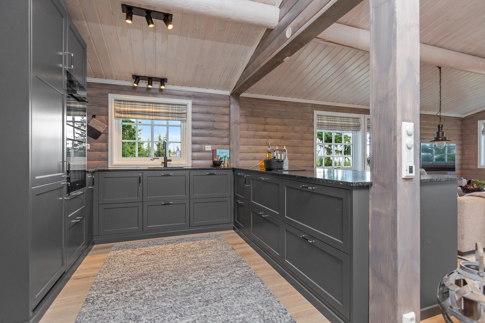 Nytt kjøkken med grå profilerte fronter, her har selger valgt en åpen løsning mot stuen og spisestuen Galleribilde