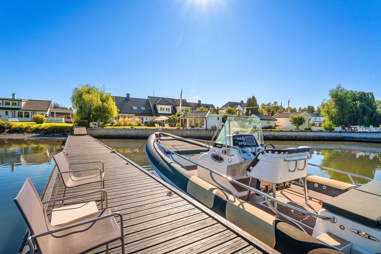 Langs strandlinjen er det støpt ny støttemur belagt med terrassebord som fører ut på en ny brygge i stålkonstruksjon. Galleribilde