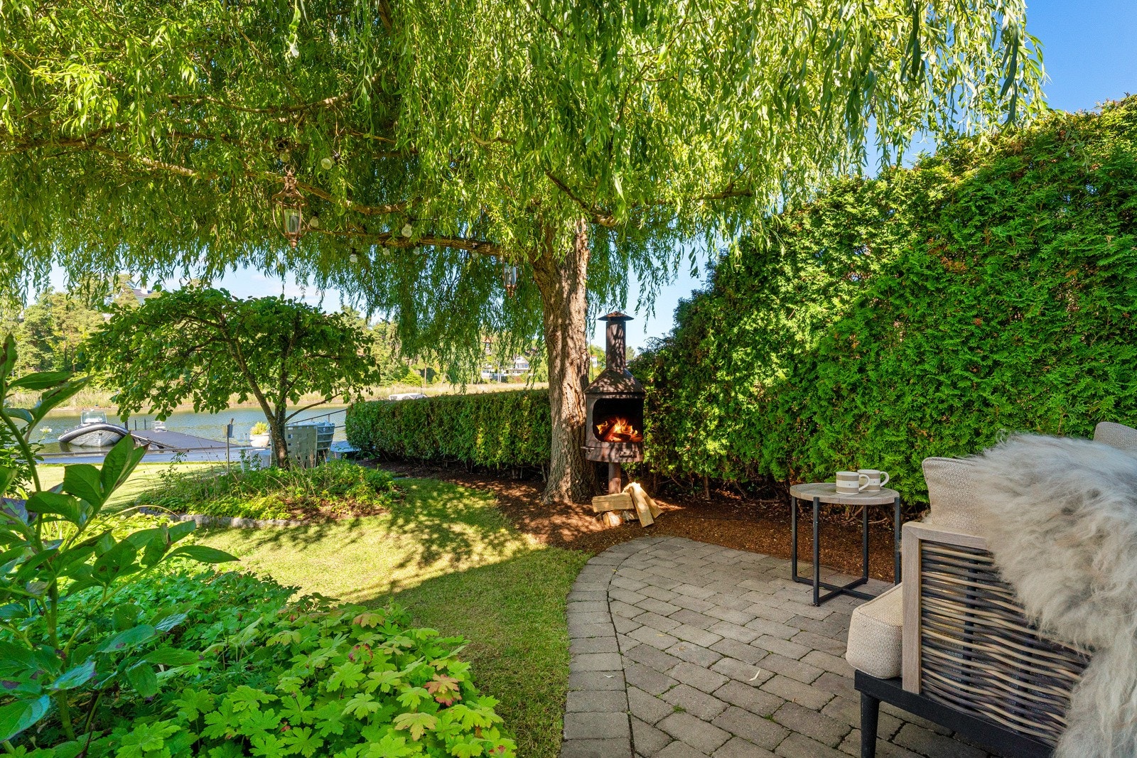 Eiendommen er usjenert, og det er fine uteplasser hvor sommeren kan nytes til det fulle, deriblant en stor skiferterrasse med sjøutsikt, samt plen, staudebed og sand i skjønn forening. Galleribilde