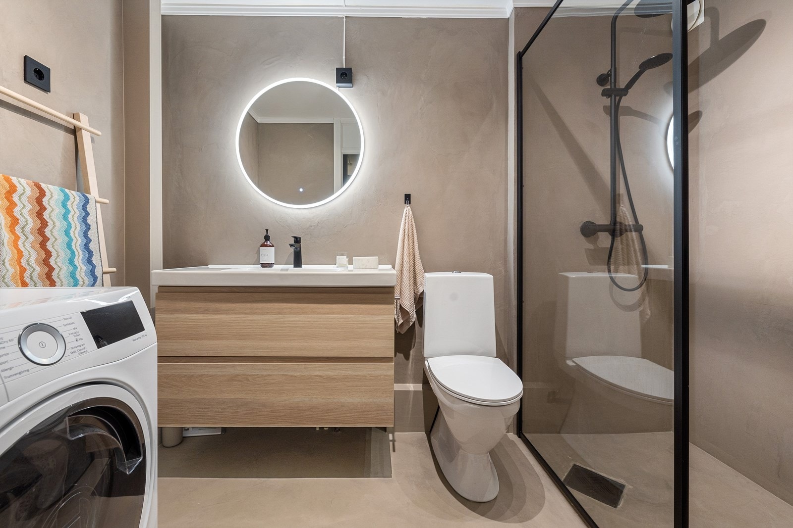- På badet er det speil med belysning, klosett, servant med oppbevaringsskap, varme i gulv og opplegg for vaskemaskin - Galleribilde