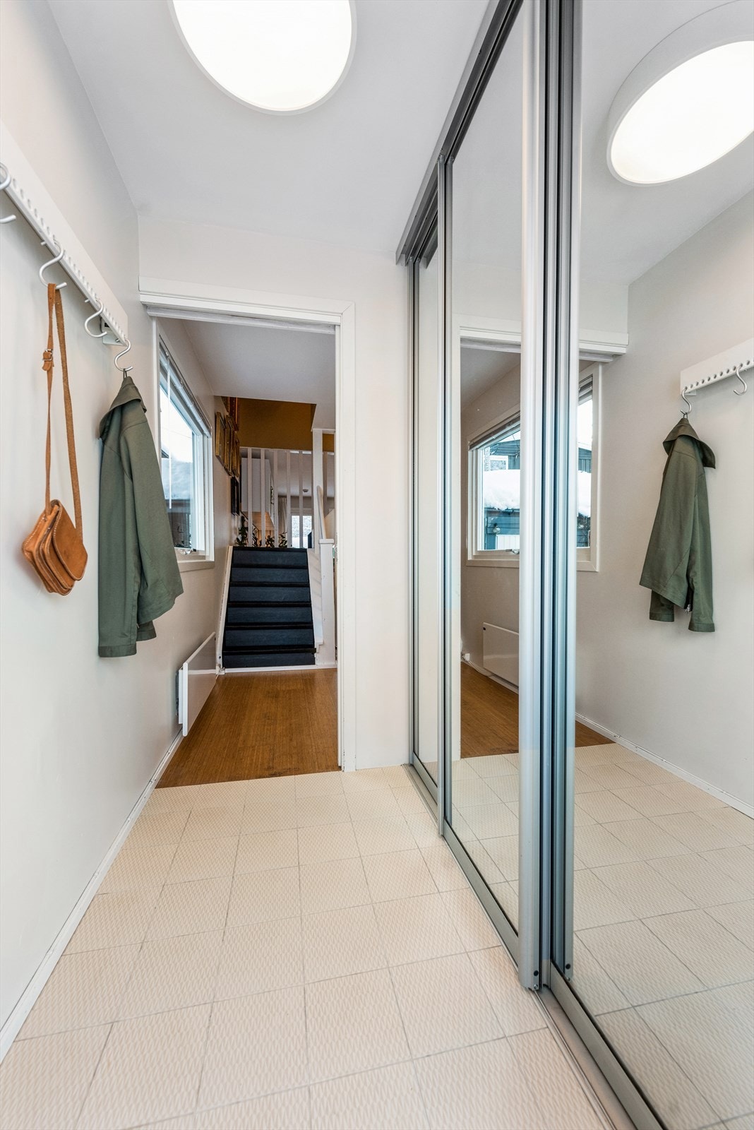 Lys entré med godt med oppbevaringsmuligheter i praktisk skyvedørsgarderobe. Galleribilde