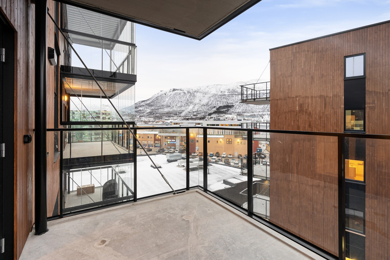 Overbygd balkong utenfor hovedsoverom med utsikt mot fastlandet og Fløya/Fjellheisen.
