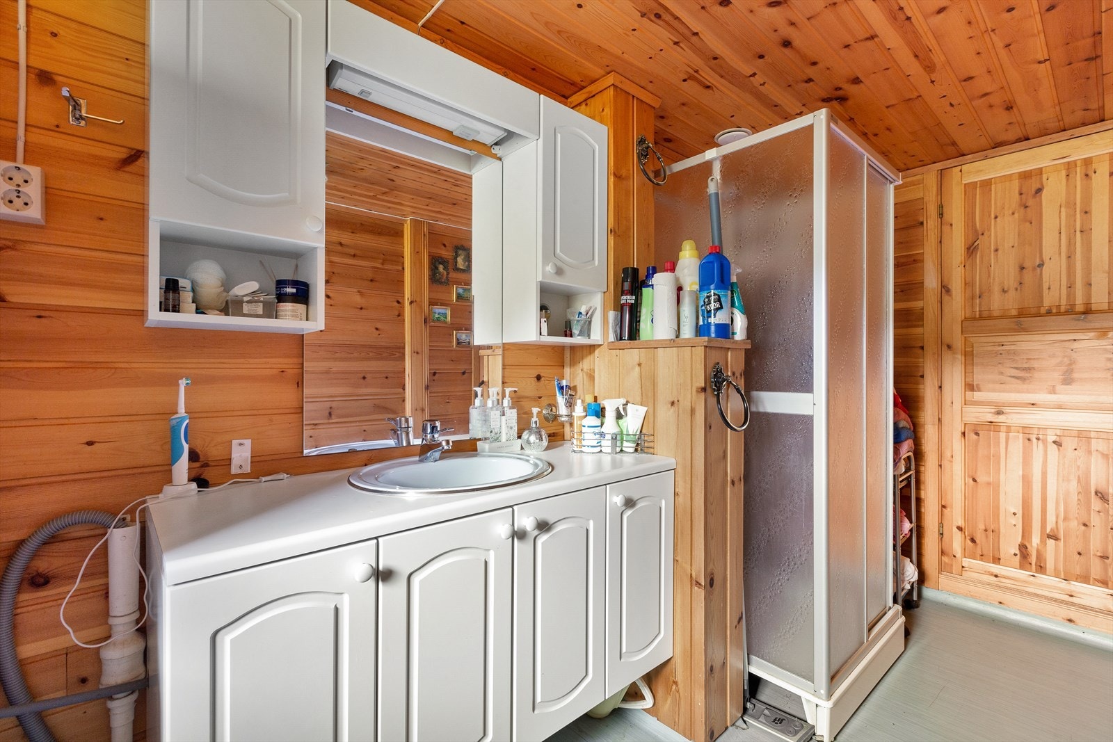 Badet inneholder opplegg til vaskemaskin, dusj, toalett og baderomsinnredning Galleribilde