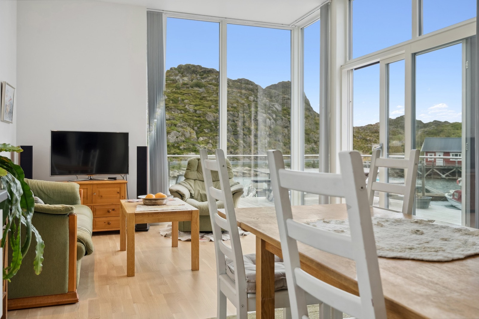 Stua har vindu fra tak til gulv, med lameller som kan gi mindre innsyn og skjerme deg fra sola Galleribilde