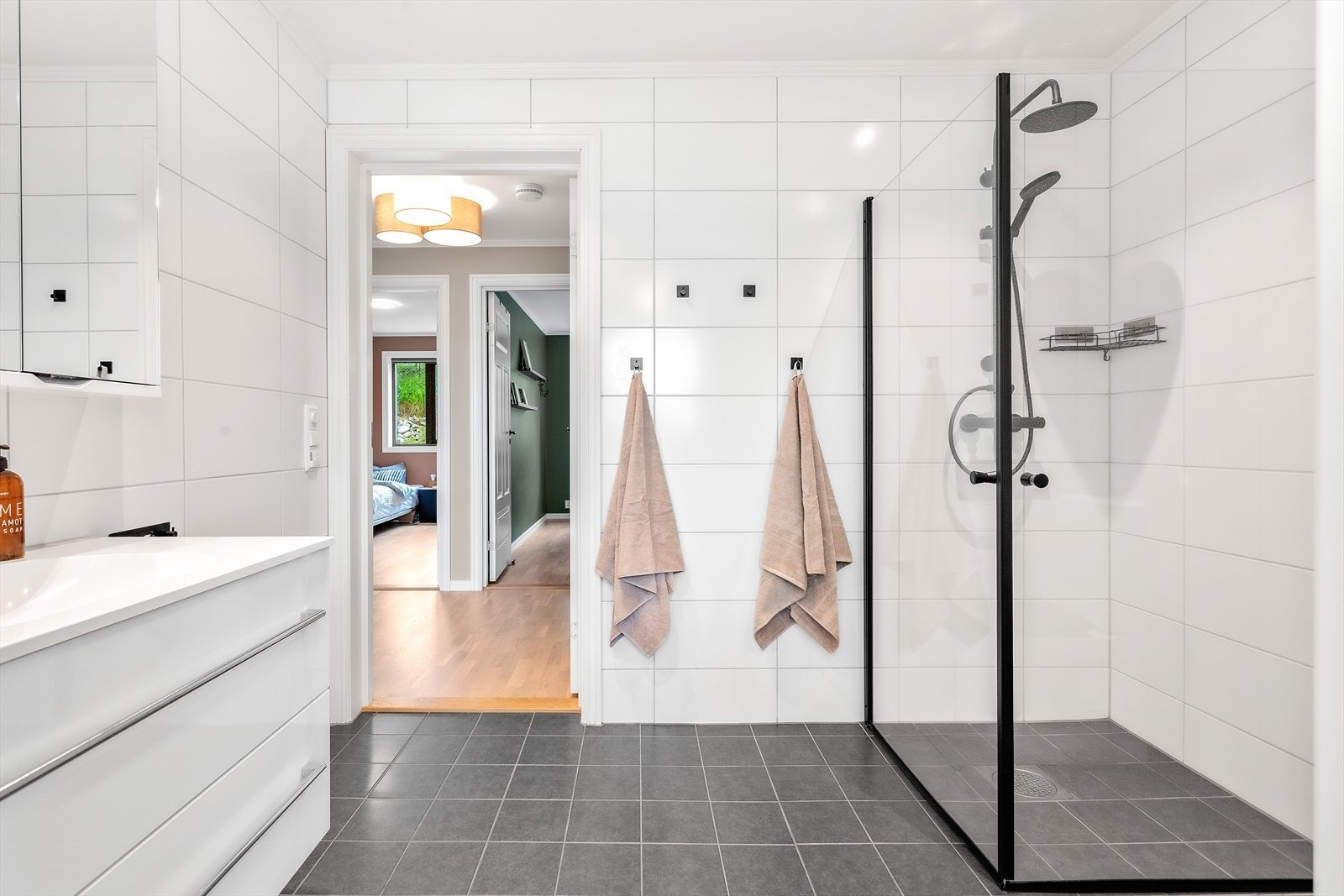 Romslig bad som er flislagt og har varmekabler i gulv og downlights i tak. Galleribilde