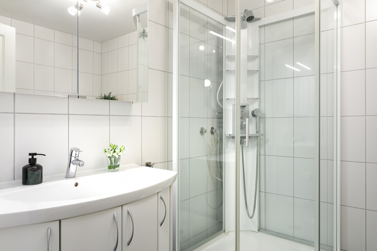 Badet er innredet med baderomsinnredning, dusjkabinett og wc. Galleribilde