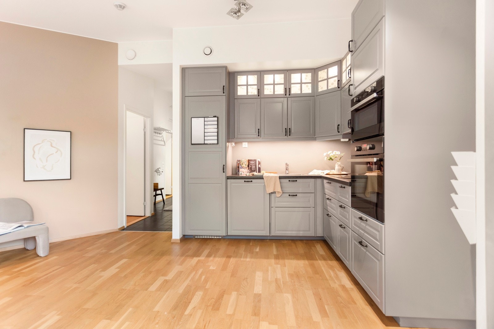 Kjøkken med mye oppbevaringsplasser og integrerte hvitevarer Galleribilde