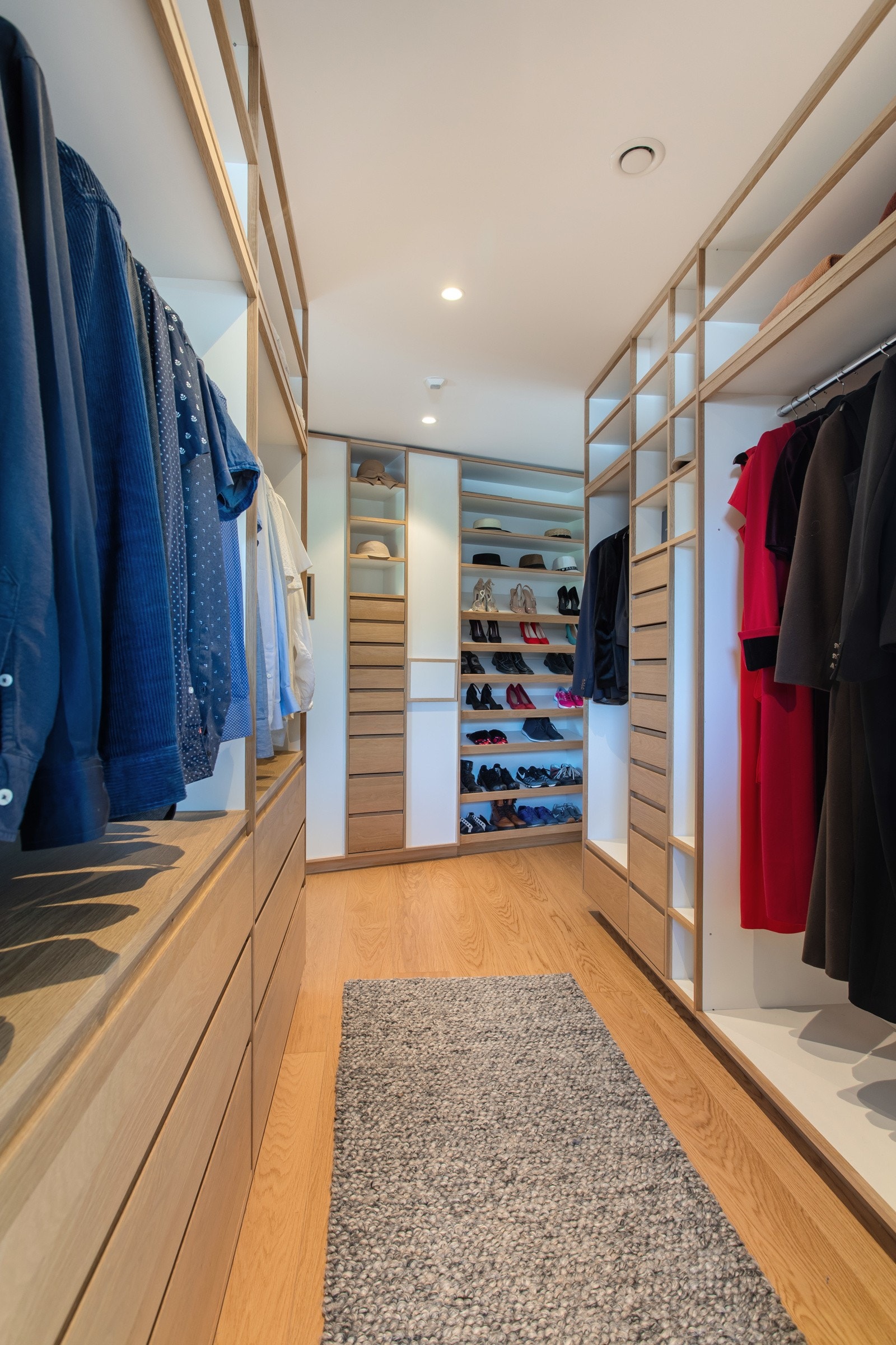 Walk-in-closet med plassbygget garderobe, innebygd safe og klessjakt til vaskerom. Galleribilde