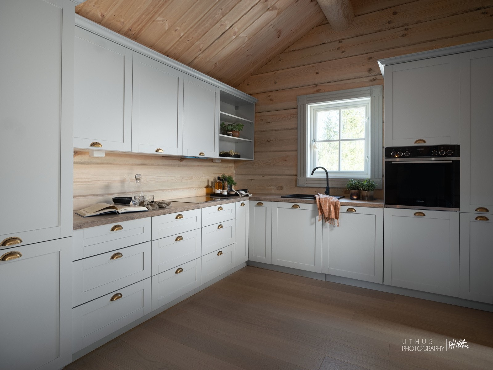 Tiltalende lysgrå innredning med profilerte fronter og benkeplate i laminat. Galleribilde