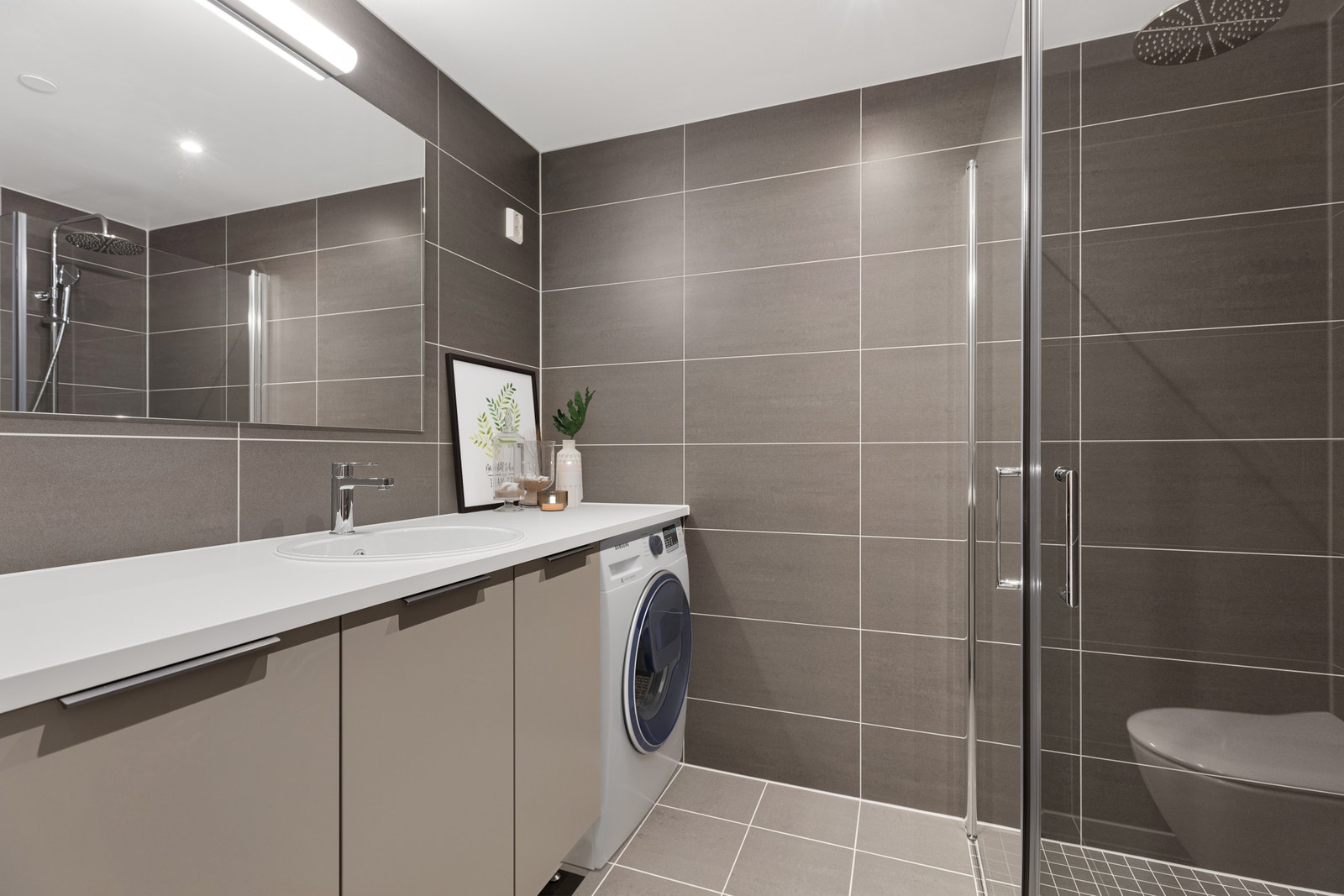 Pent flislagt bad med varme i gulv og downlights i himling. Bildet er digitalstylet. Galleribilde