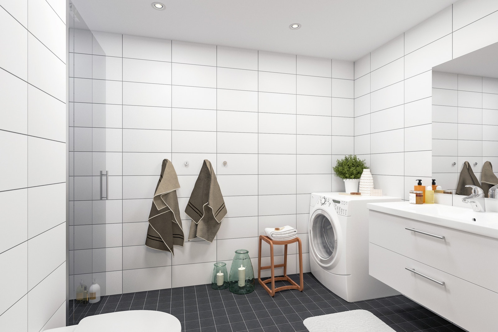 Bad med varmekabler, dusjnisje, vegghengt WC og opplegg for vaskemaskin og tørketrommel. Galleribilde