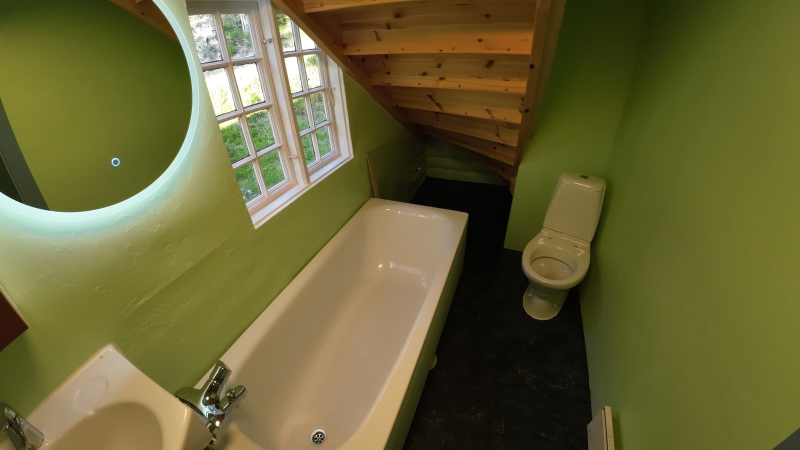Badet har håndvask, badekar og wc. Galleribilde