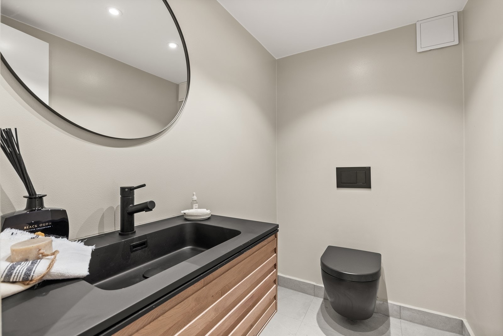 Toalettrom med vegghengt toalett og servant med underskap. Galleribilde