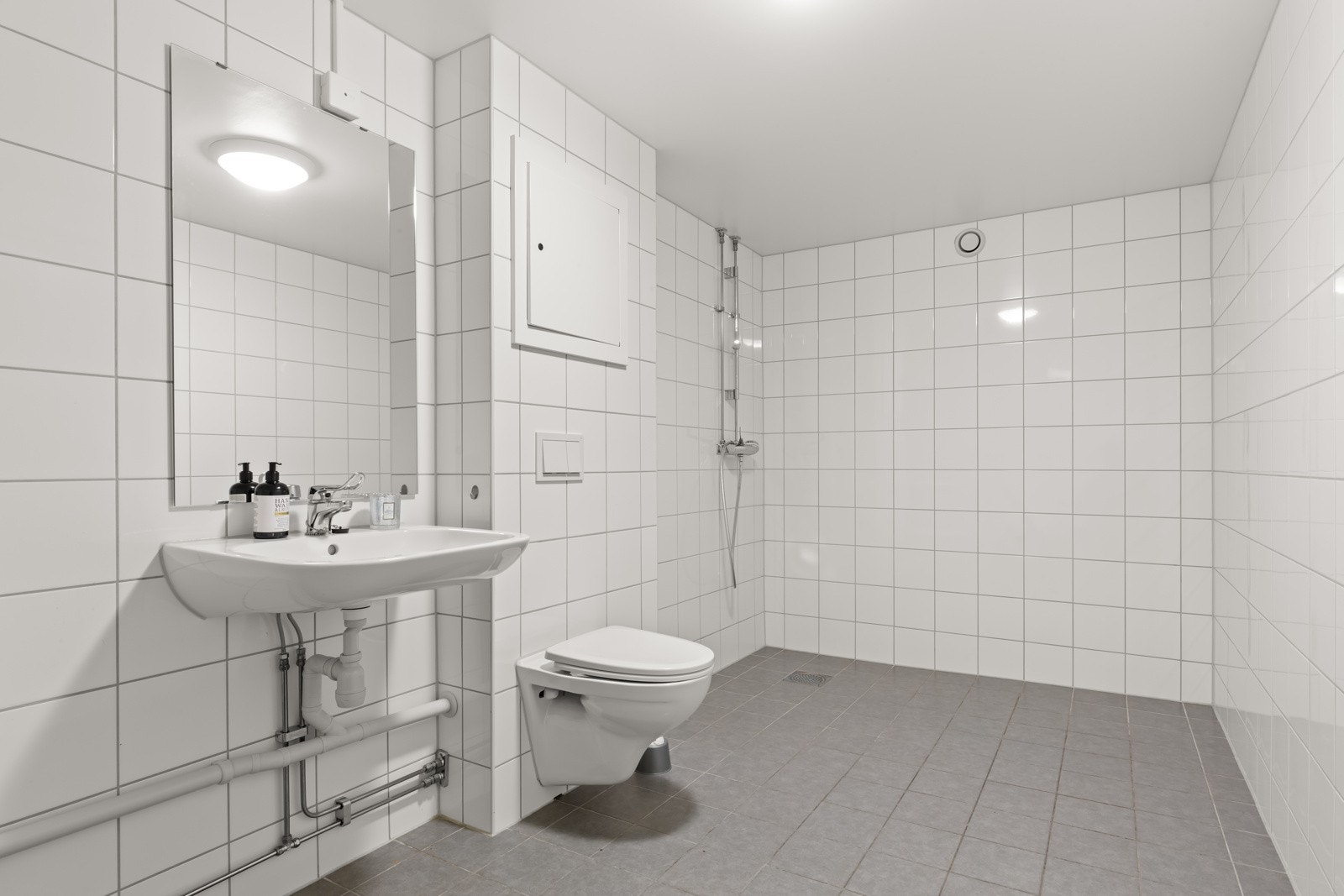 Stort åpent bad oppusset i regi av borettslaget 2017/18. Åpen dusj, vegghengt wc, vask og plass for vask/tørk. Galleribilde