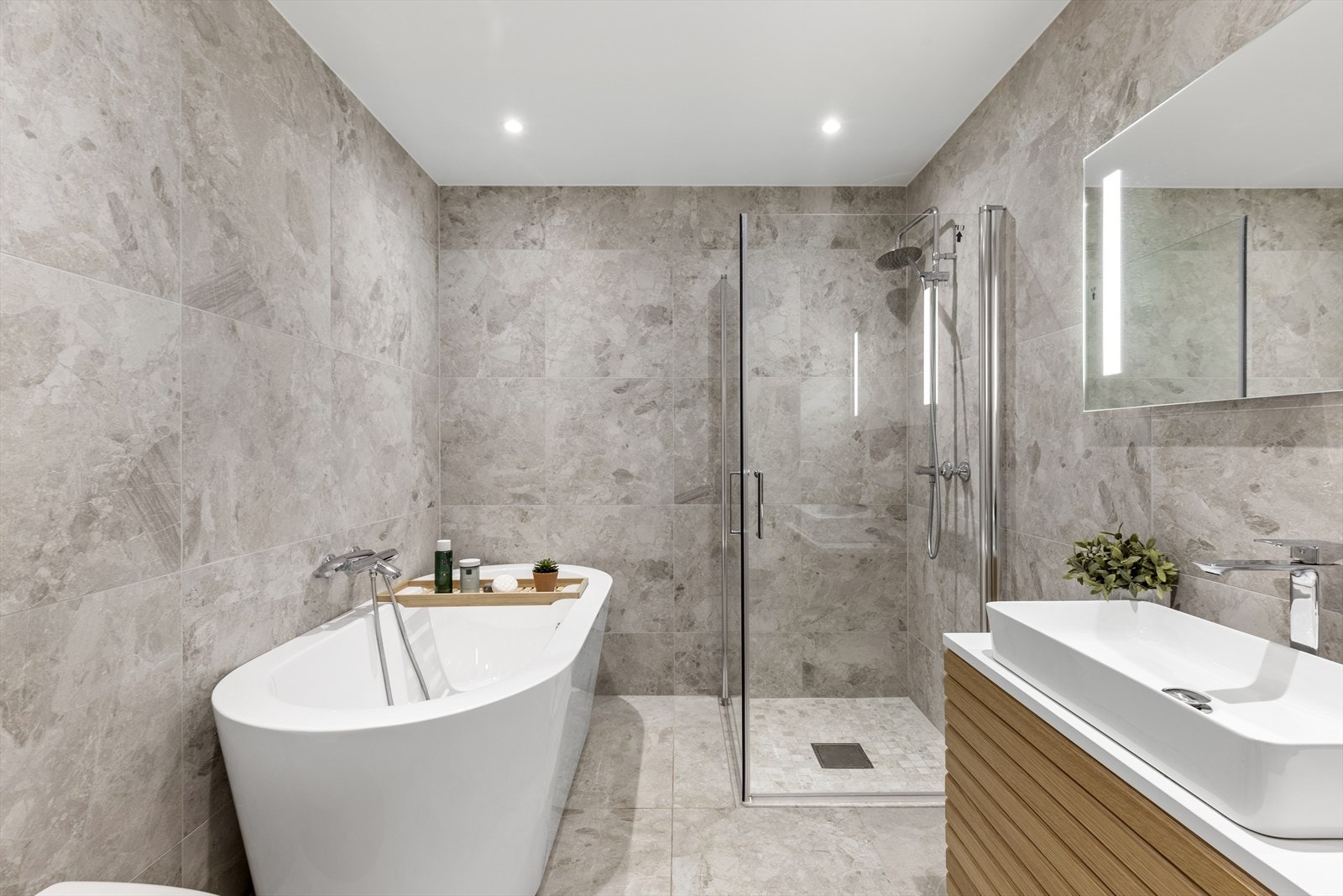 Badet i 2. etasje har innredning med nedfelt servant, veggmontert toalett, badekar og dusjvegger/hjørne Galleribilde
