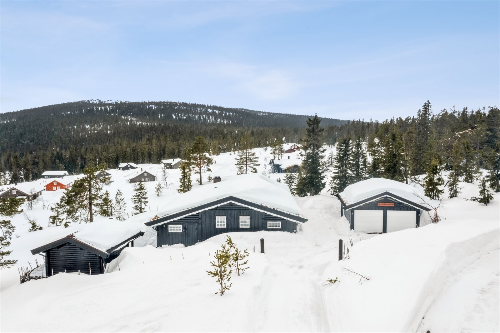 Stor og solrik fritidseiendom beliggende høyt i hyttefeltet og med fin utsikt. Eiendommen er bebygd med en hytte over ett plan, frittstående garasje og et anneks. Galleribilde