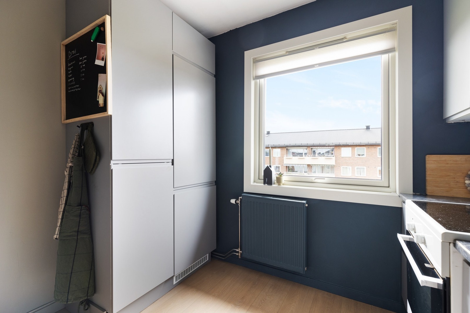 Kjøkkenet er ellers utstyrt med frittstående komfyr, integrert oppvaskmaskin og integrert kjøl/frys Galleribilde