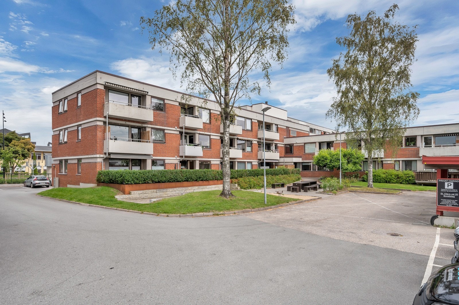 Fellesareal med gressplen og sittebenker. Gode parkeringsmuligheter på tomt Galleribilde