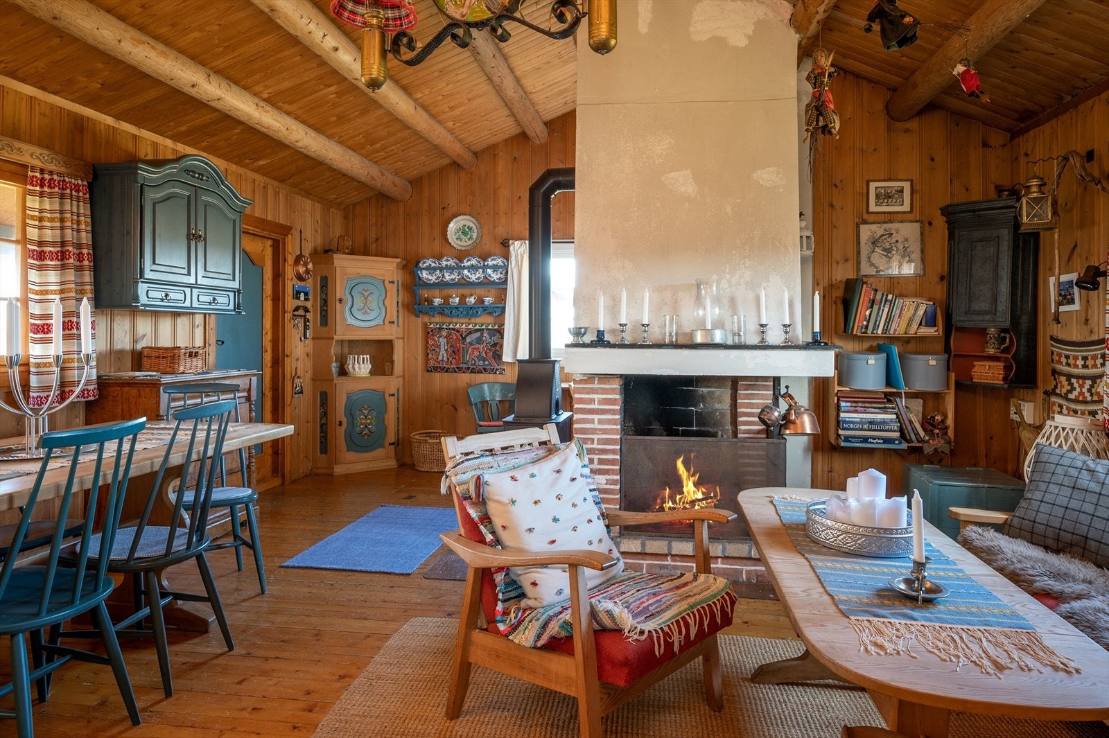 Hytta har stue, kjøkken og spisestue i åpen løsning Galleribilde