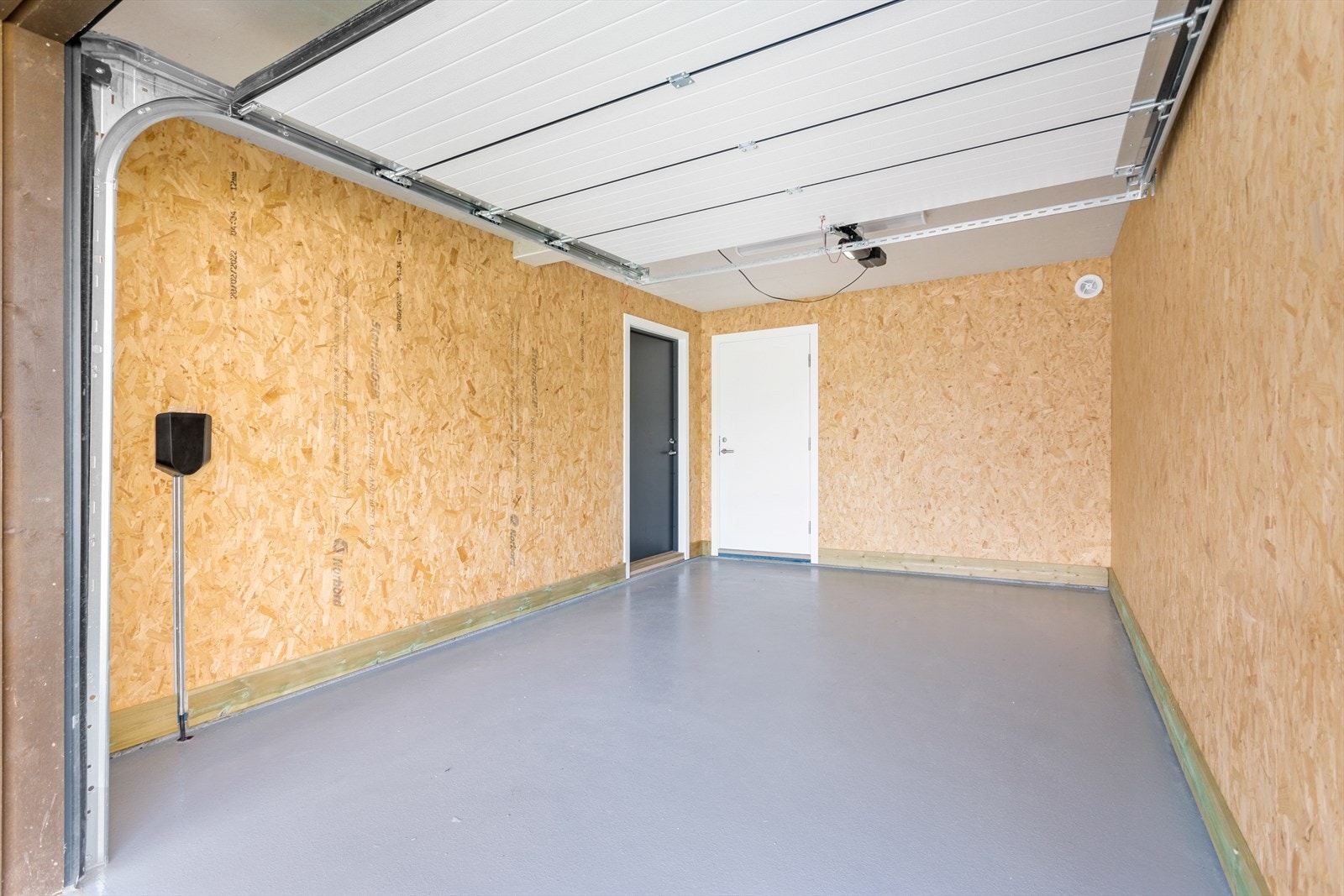 Romslig garasje hvor det er montert elbillader. Galleribilde