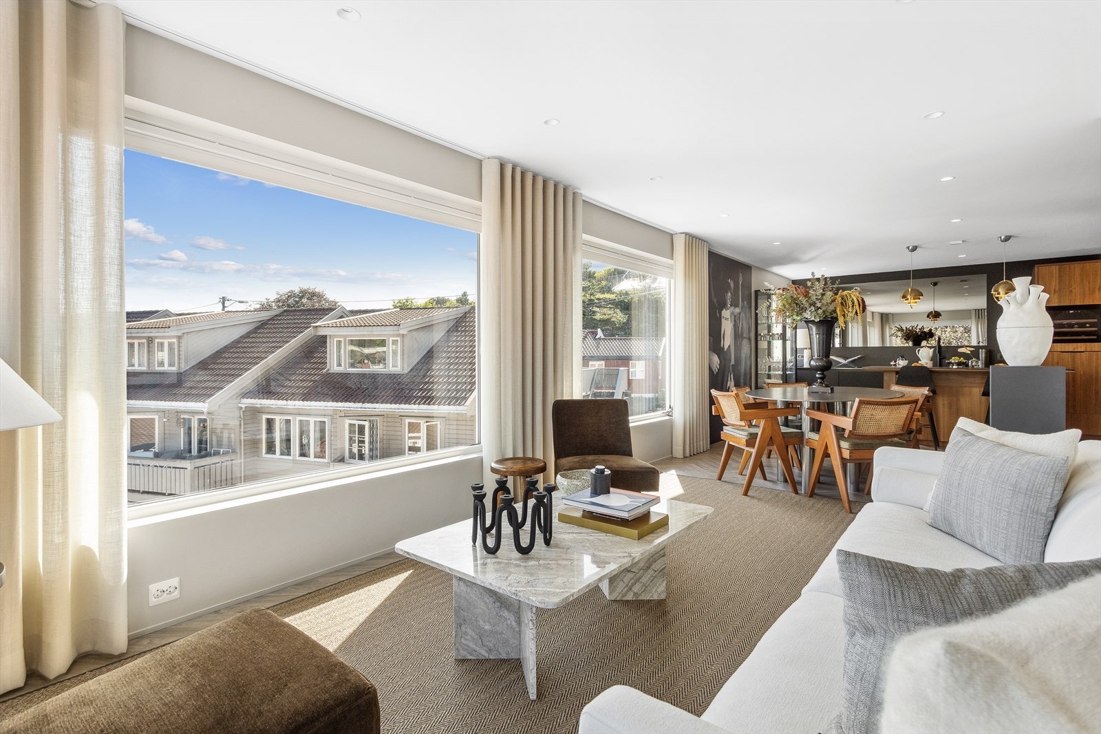 Stuen nyter godt av både utsikt og godt med lys fra de store vindusflatene - her er det også montert måltillpassede persienner. Galleribilde