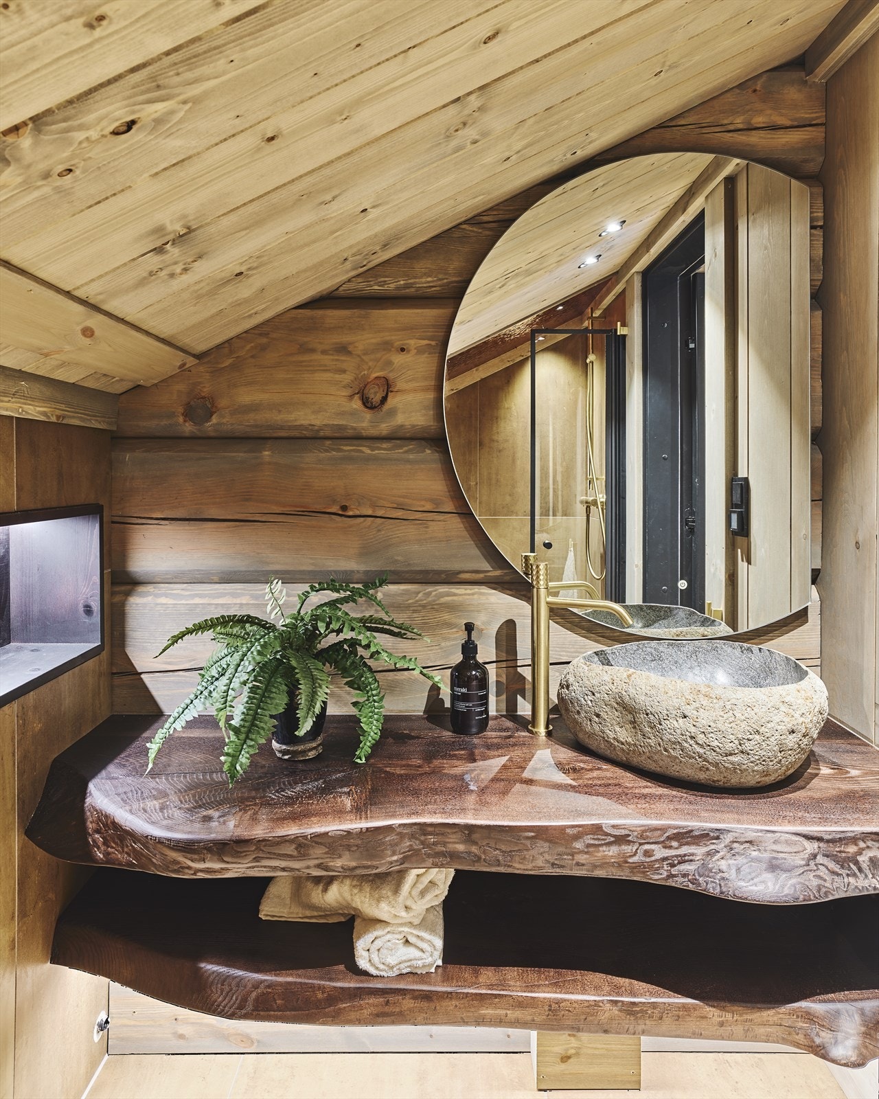 Badet på hems består av servantskap med naturformet kant, hyller i samme material under, og hyller i veggnisjer i beiset furu. Videre er det Bali steinvask fra By Bjorkheim og servantbatteri i børsta gull. Galleribilde